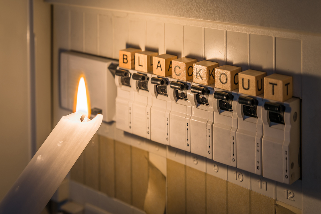 Wooden blocks spelling 'blackout' during a power outage in need of an emergency electrician. 