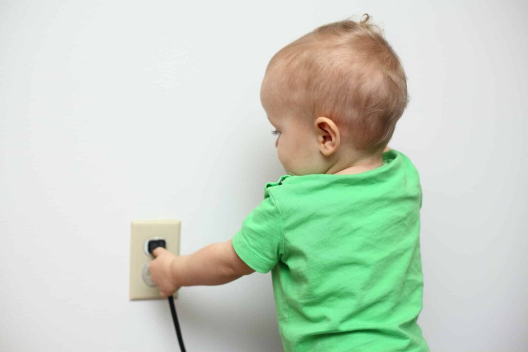 Childproof Electrical Outlets Child Tampering With Plug.